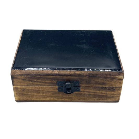 Wooden box with black lid on a white background