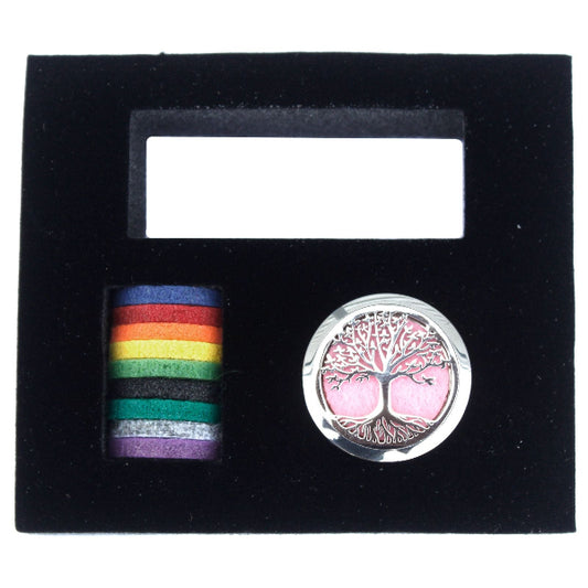 Two pins in a black display case: one rainbow-colored and one with a tree design.