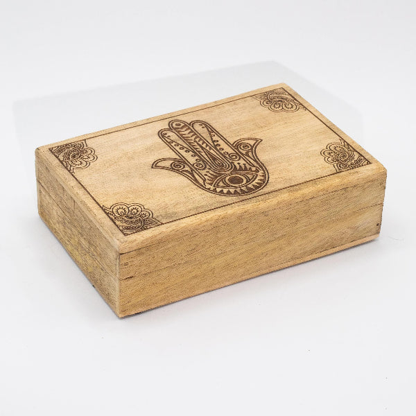 Wooden box with Hamsa hand design on a white background