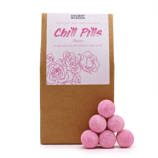 Pink bath bombs with a cardboard box labeled 'Chill Pills Rose' on a white background