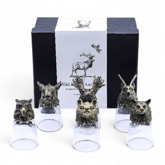 Set of animal head-shaped decanters with a branded box in the background