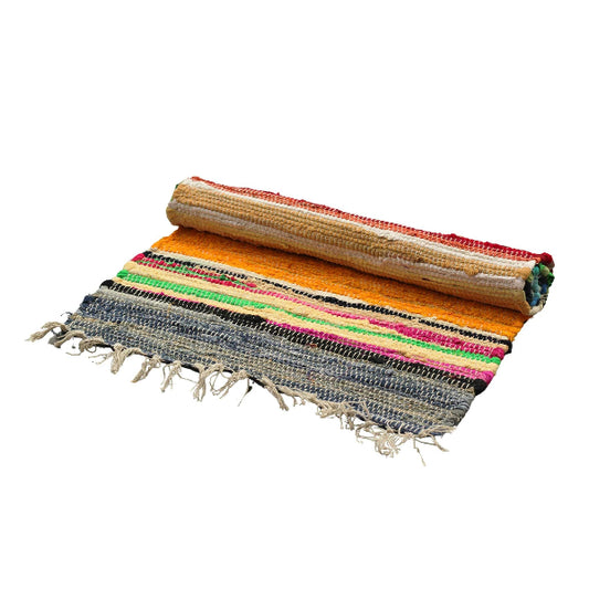 Multicolored woven rug with fringe on a white background