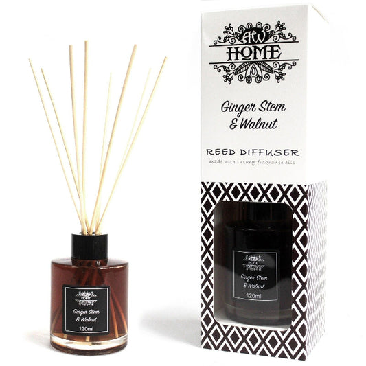 Reed diffuser with ginger stem and walnut scent next to its packaging on a white background