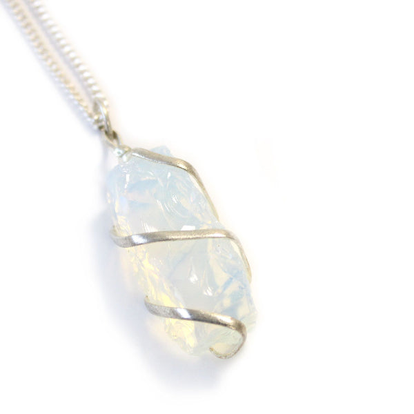 Opal pendant with silver wire wrapping on a white background