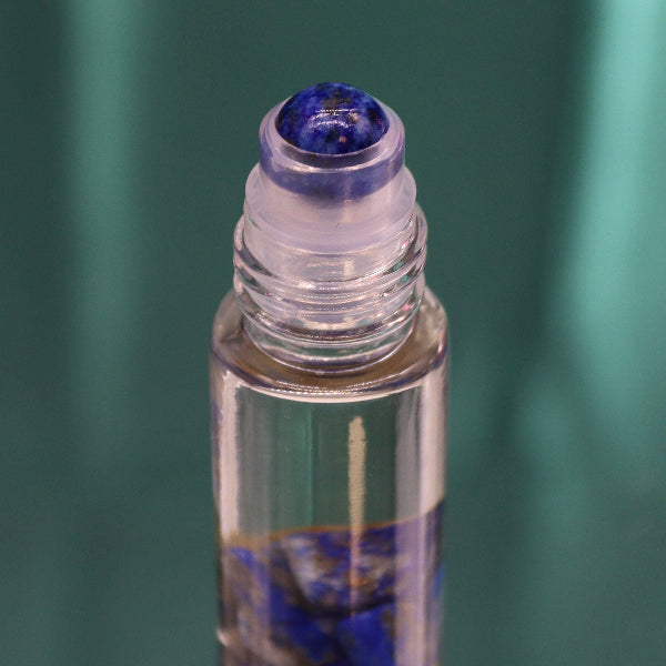 Roll-on bottle with a blue cap against a green background