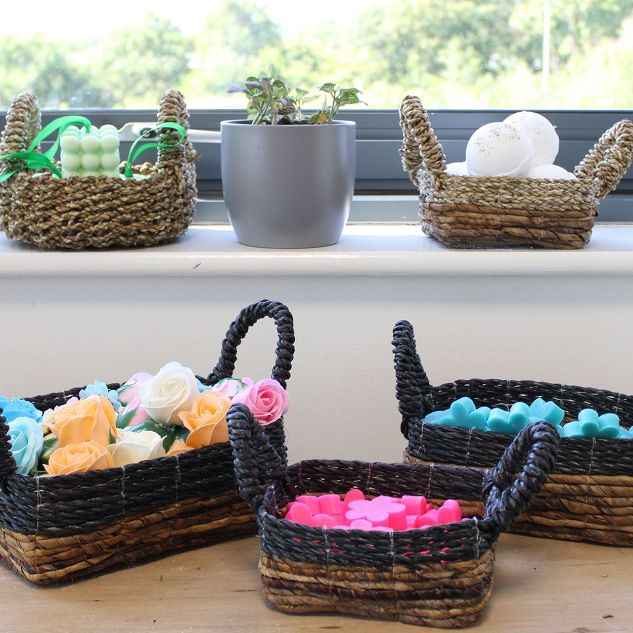 Wicker baskets with colorful items on a windowsill