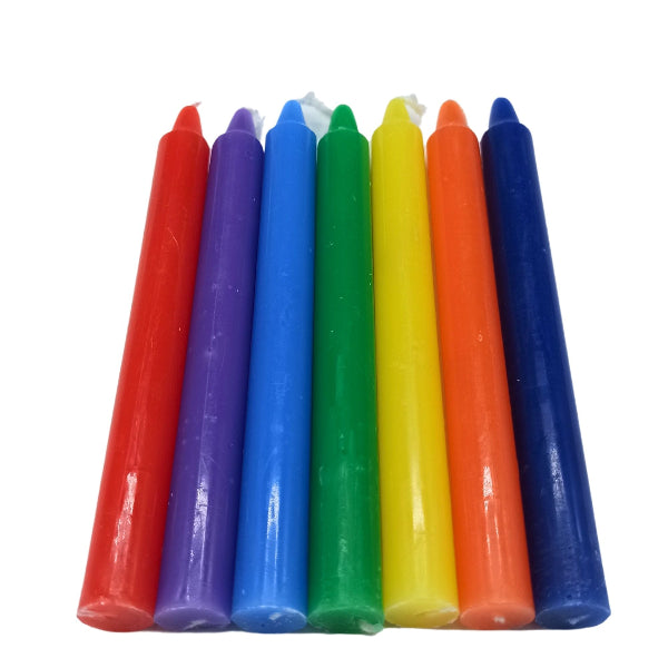 Set of colorful candles in red, purple, blue, green, yellow, orange, and blue on a white background