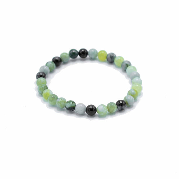Beaded bracelet with green and black beads on a white background
