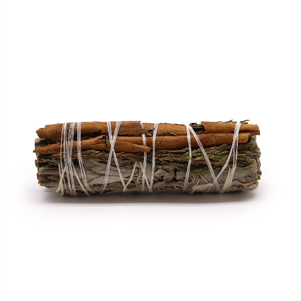 Rolled sage bundle with cinnamon sticks on a white background