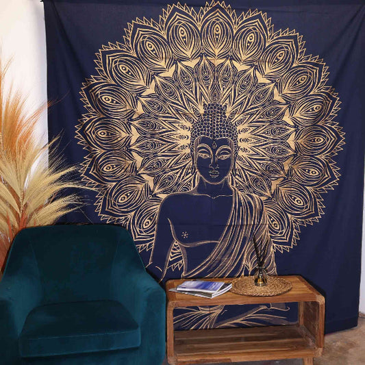 Tapestry with Buddha design hanging on a wall above a blue armchair and wooden table.