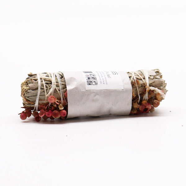 Rolled sage bundle with red berries on a white background