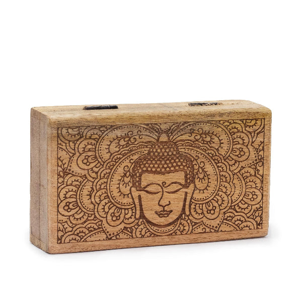 Wooden block with engraved Buddha face and mandala design on a white background