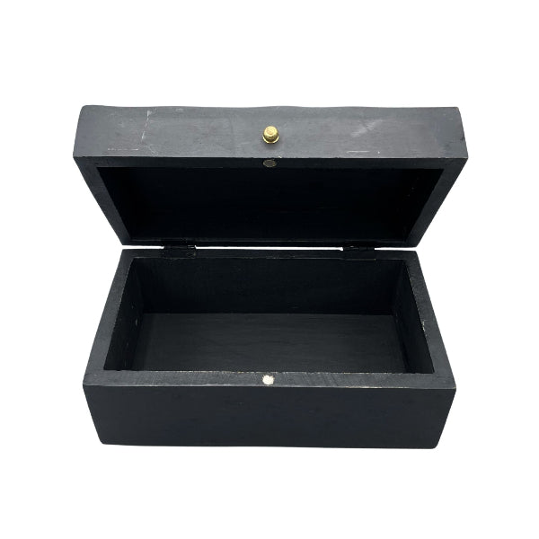 Black wooden box with a gold button on a white background
