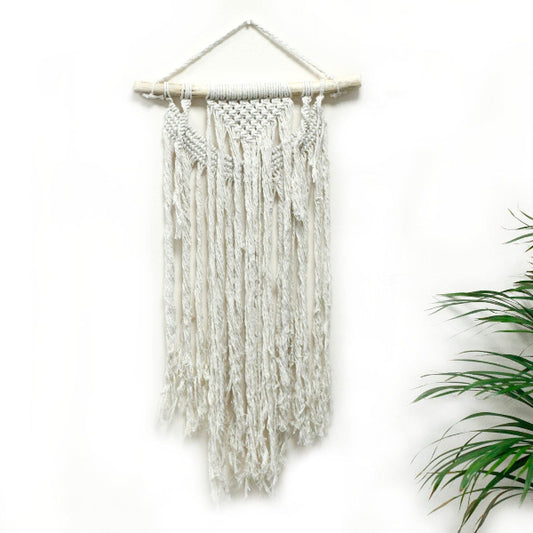 Macrame wall hanging with white yarn on a white background