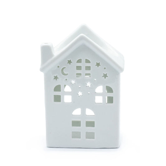 White house-shaped lantern with cut-out patterns on a white background
