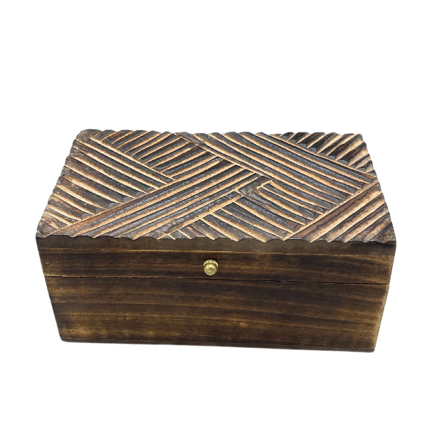 Wooden box with a textured top and metallic clasp on a white background
