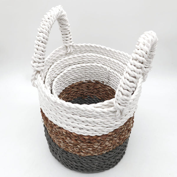 Woven basket with white top, brown middle, and gray bottom on a light gray background