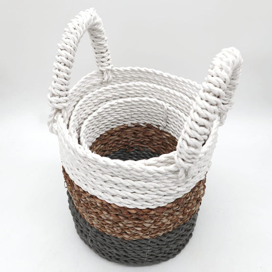 Woven basket with white top, brown middle, and gray bottom on a light gray background