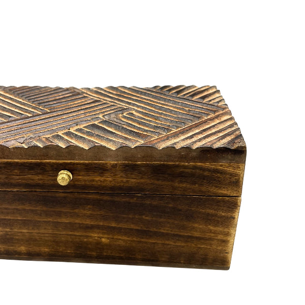 Wooden box with textured top and gold clasp on a white background