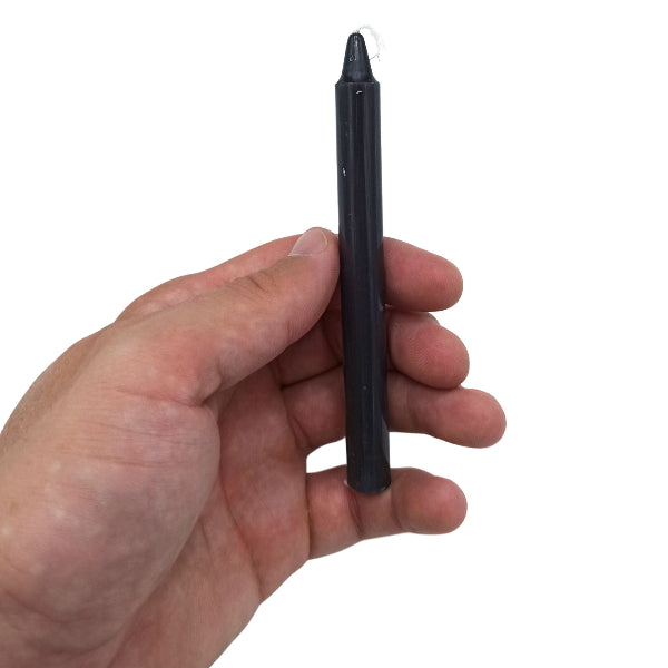Hand holding a black stylus pen against a white background