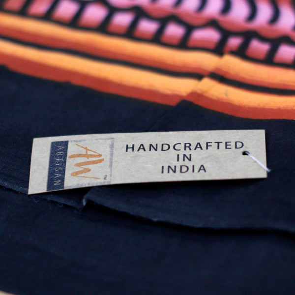 Textile with a 'Handcrafted in India' label on a colorful background