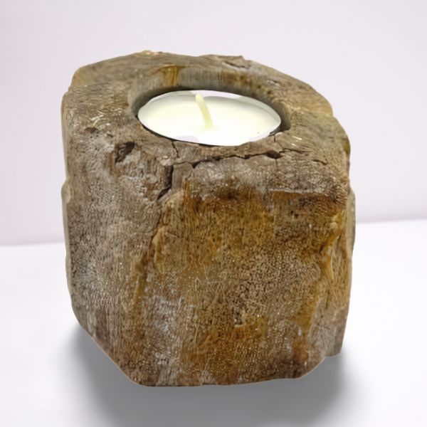 Candle holder made of natural stone with a white candle inside on a white background