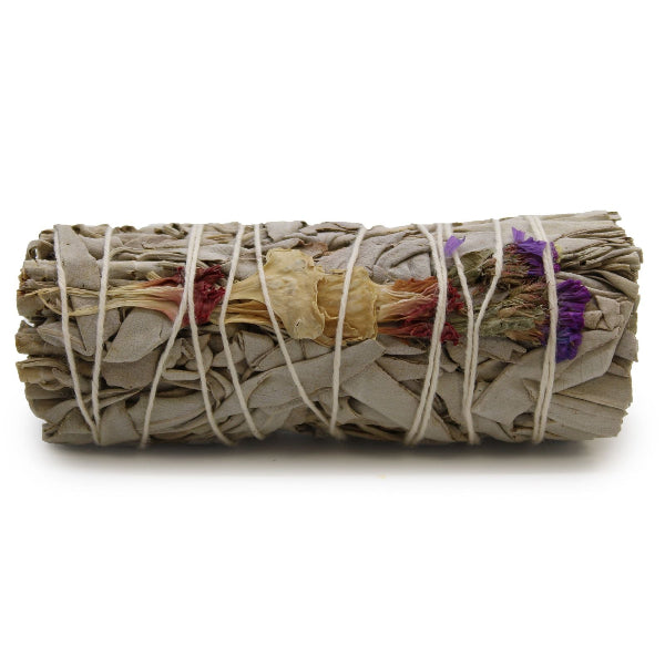 Rolled sage bundle with colorful leaves tied with twine on a white background