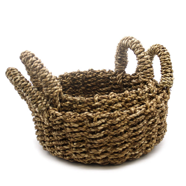 Woven basket with handles on a white background