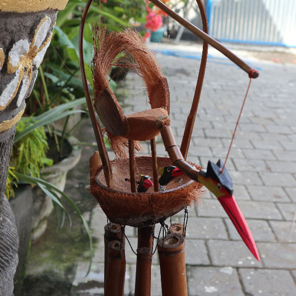 Wooden bird feeder with birds on a stand outdoors