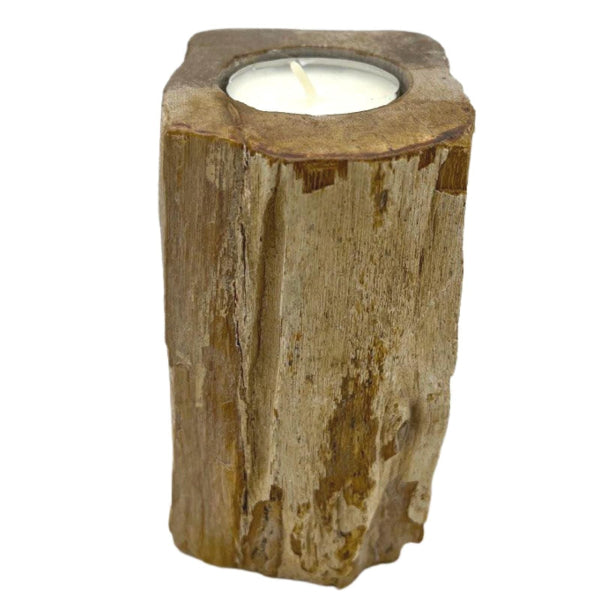 Candle holder made of natural wood with a white candle inside on a white background