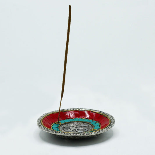 Decorative incense holder with a single incense stick on a white background