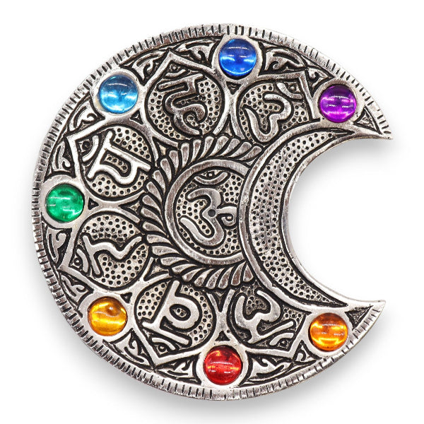 Decorative metal piece with colorful gemstones on a white background