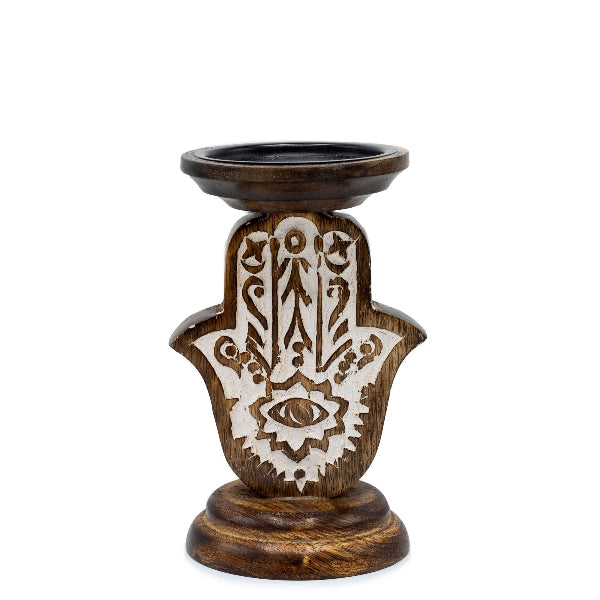 Wooden candle holder with Hamsa hand design on a white background