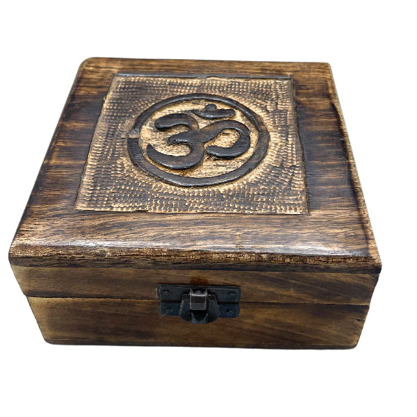 Wooden box with Om symbol on a white background