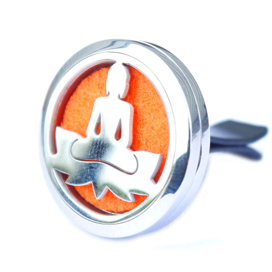 Metallic pendant with a meditating figure on an orange background