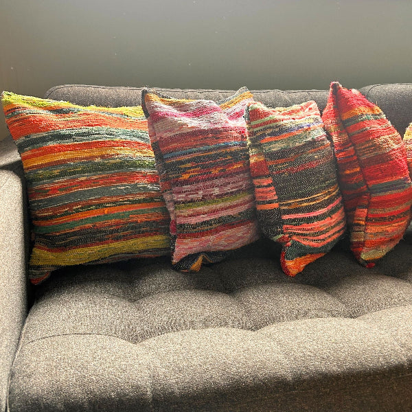 Colorful striped pillows on a gray sofa