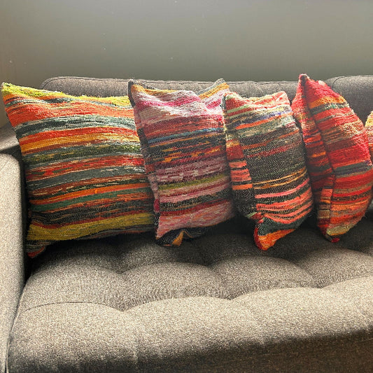Colorful striped pillows on a gray sofa