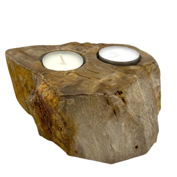 Two candle holders embedded in a natural stone block on a white background
