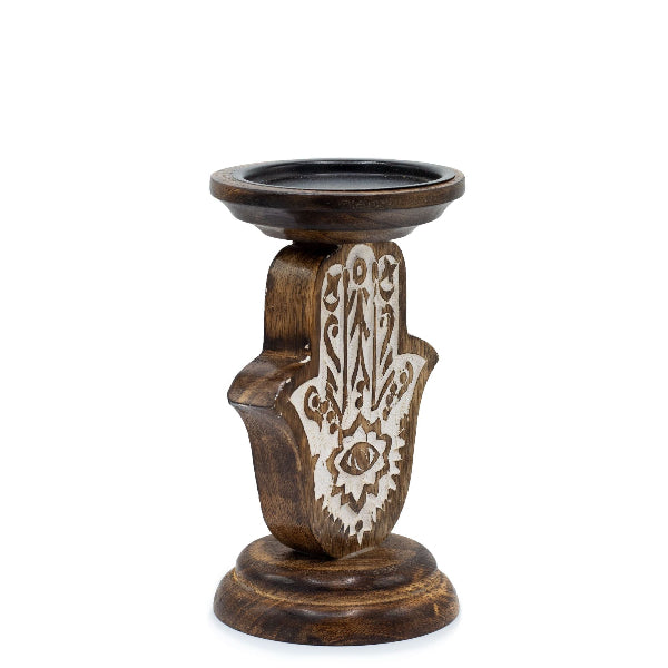 Wooden candle holder with Hamsa hand design on a white background