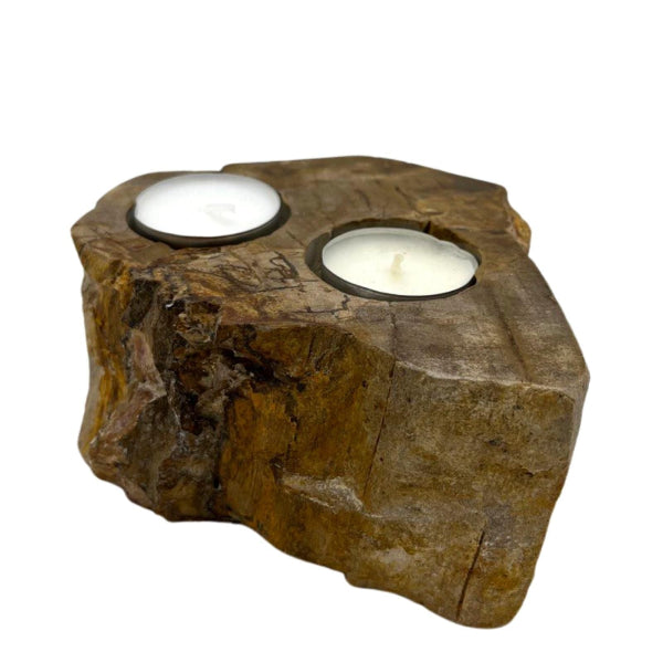 Rustic wooden candle holder with two candles on a white background