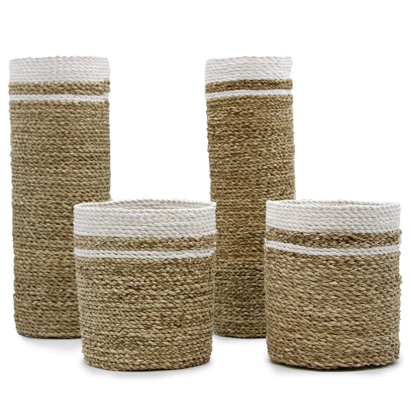 Set of four woven baskets with white bands on a white background