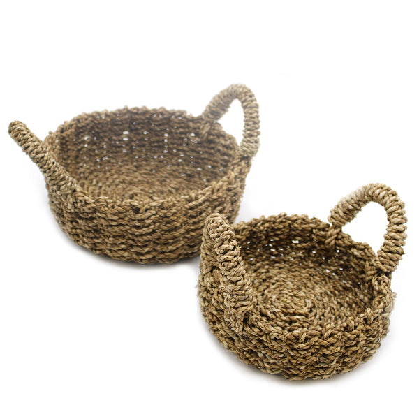 Two woven baskets with handles on a white background
