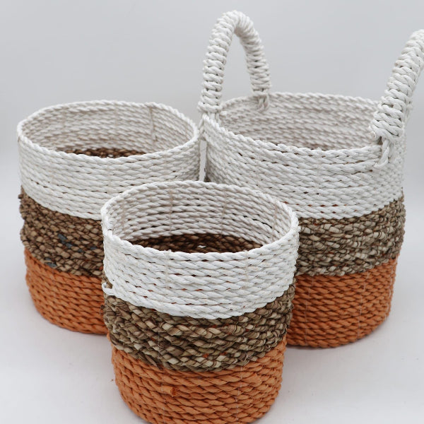 Three woven baskets with a striped pattern on a light background