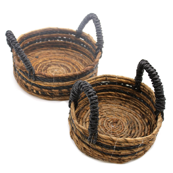 Two woven baskets with black handles on a white background