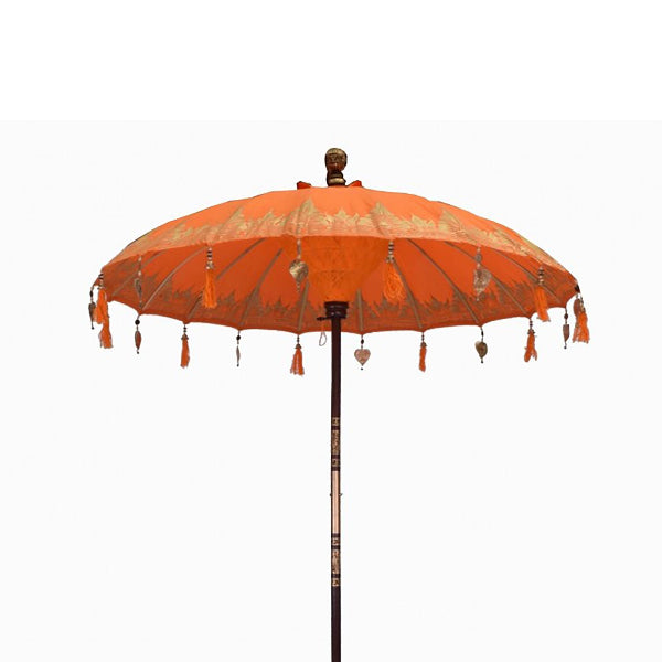 Orange decorative umbrella with tassels on a white background
