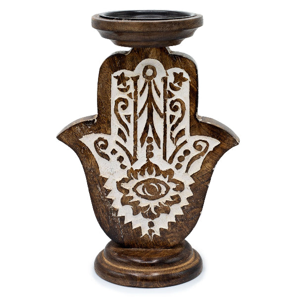 Wooden candle holder with Hamsa hand design on a white background