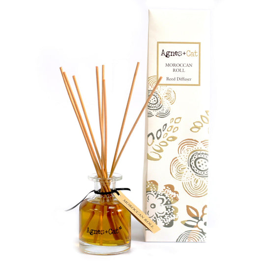 Reed diffuser with packaging on a white background