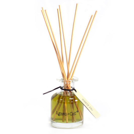 Aromatherapy diffuser with wooden sticks and a clear bottle on a white background