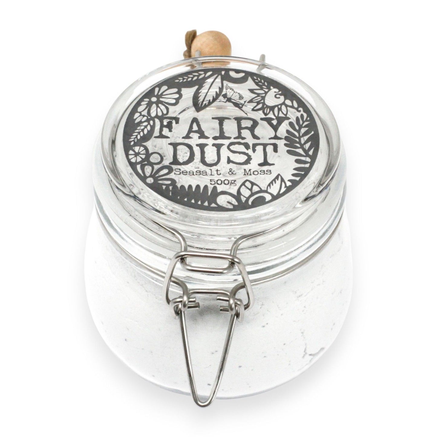 Clear jar labeled 'Fairy Dust' with decorative lid on a white background