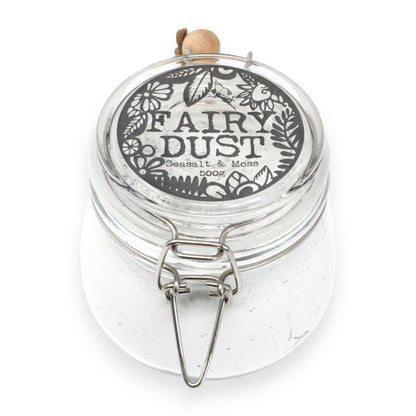 Clear jar labeled 'Fairy Dust' with decorative lid on a white background